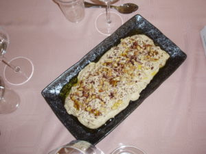 Hummus with olive oil and pine nuts